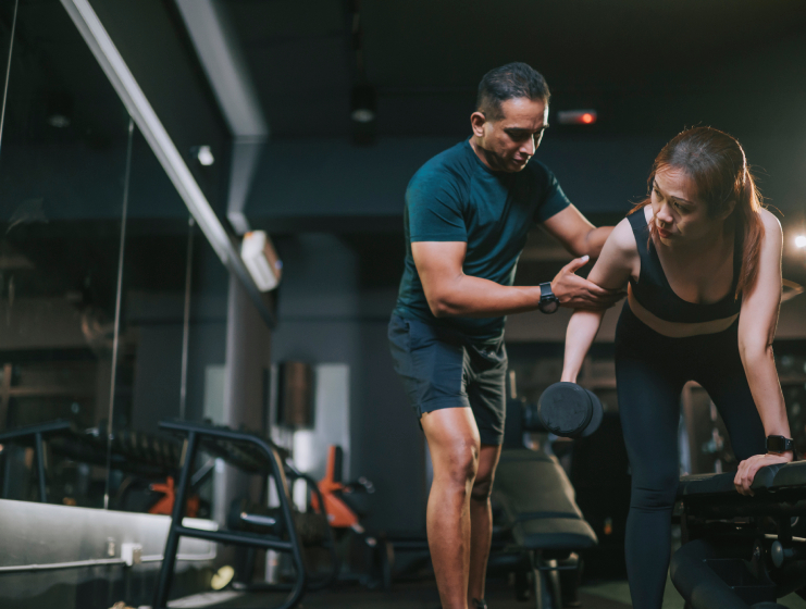 LAAC gym instructor helping client